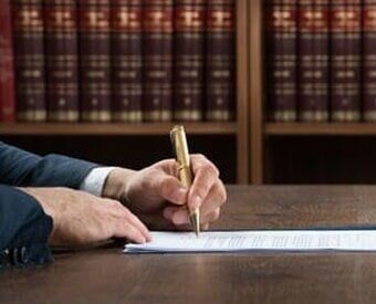 Lawyer signing something on a paper